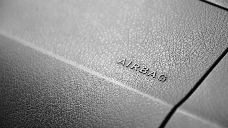 Close-up of an AIRBAG label on a car dashboard panel